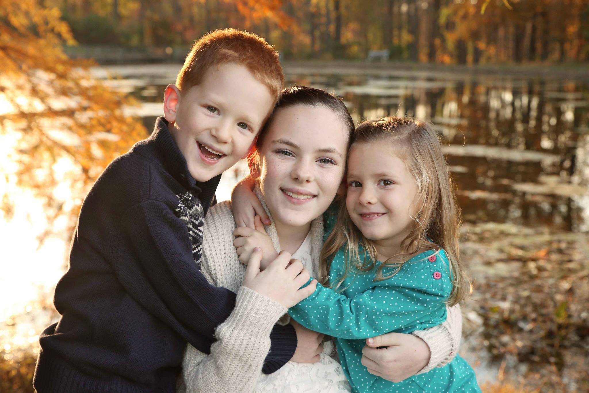 Why Everyone Needs Family Photos, Siblings Hug in front of a lake