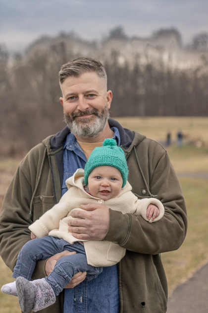 Dad holds smiling baby during Chester County Family Photography Session
