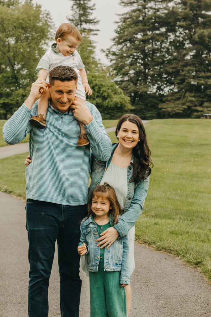 Family laughing together on path during philadelphia family photo session