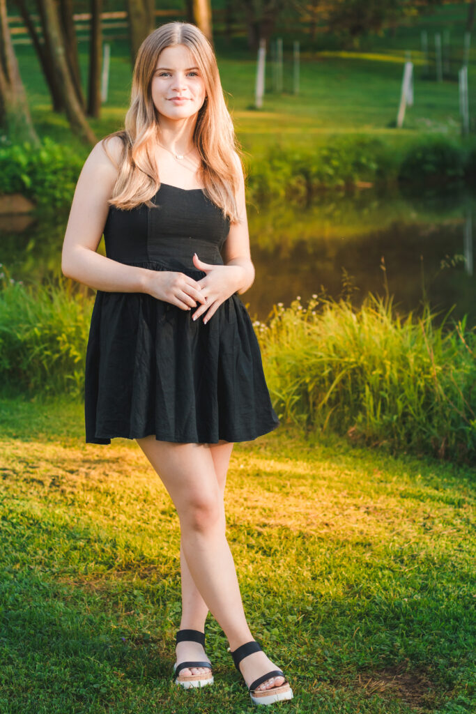 High school senior Addie posing gracefully at sunset in Baird Park