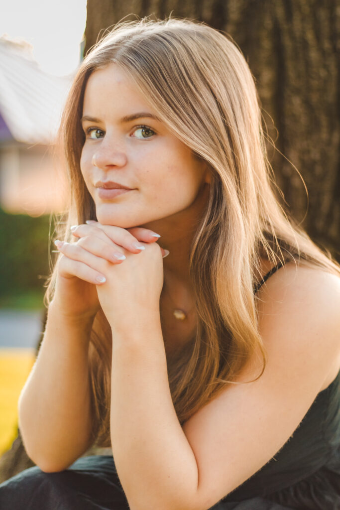 Close-up portrait of Addie with a soft, ethereal glow from the setting sun