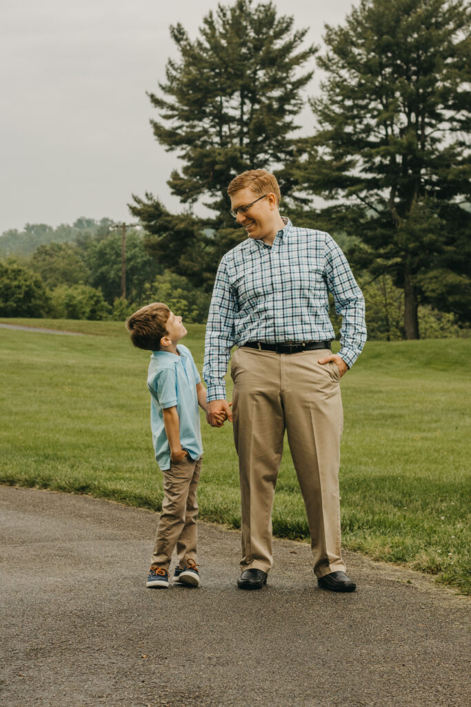 father and son smile at photo fundraiser for Holy Family School